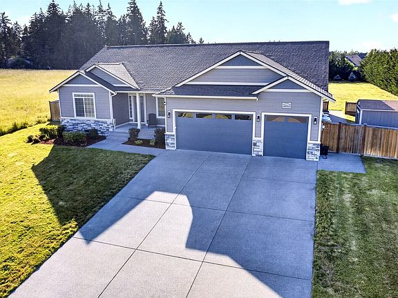 Expansive homesite with additional side-yard access, generous driveway space, and a peaceful setting.>
