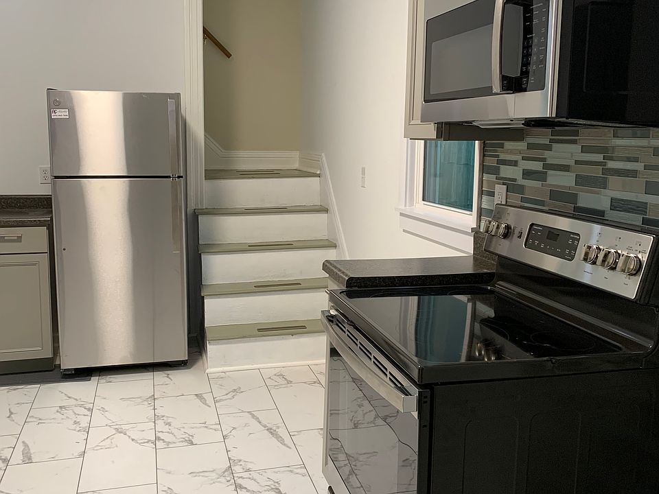 New range, new microwave with vent going outdoors, new fridge. Steps lead to upstairs rooms.