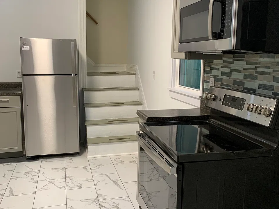 New range, new microwave with vent going outdoors, new fridge. Steps lead to upstairs rooms.