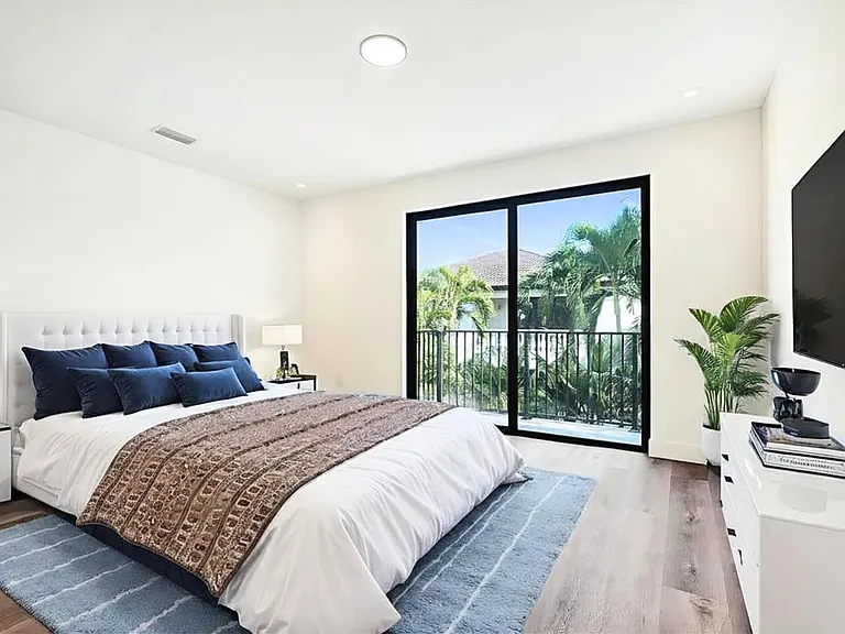 Completely private master bedroom overlooking palm trees, private pool with a private balcony ideal for morning coffee drinks while also admiring architectural details of nearby buildings and gorgeous flowers while remaining completely private.