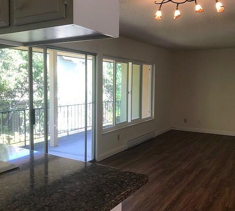 Kitchen looking into dining & living rooms and patio