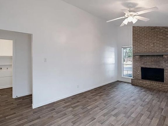 Large living room with brick fireplace and vaulted ceilings