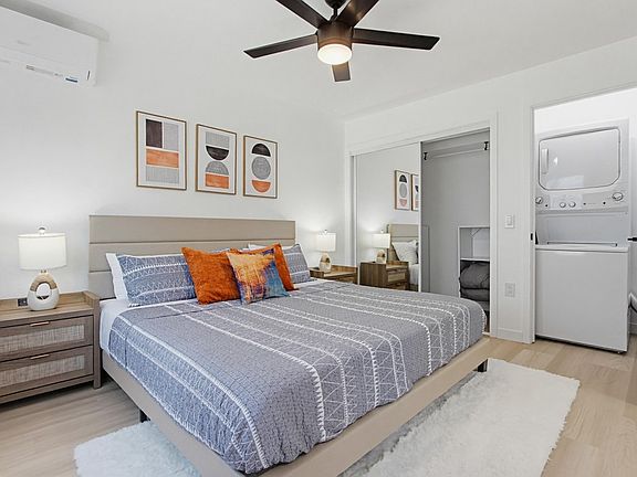 Bedroom featuring a king-size bed, attached full bath and laundry closet