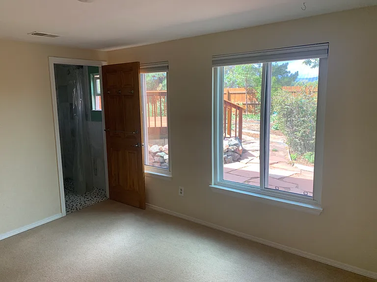 Lower level family room, play room, or bedroom with attached bathroom