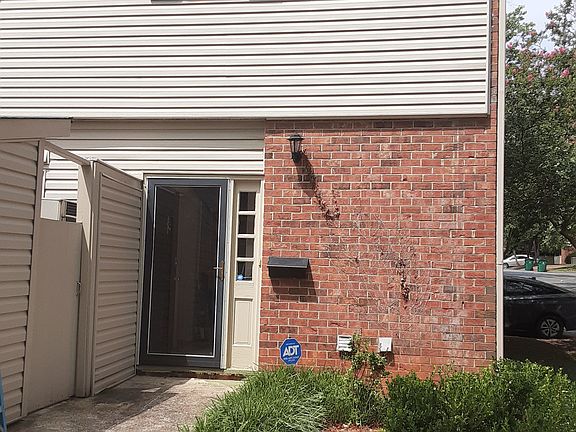 Front Door with side entrance to enclosed patio and enclosed storage unit