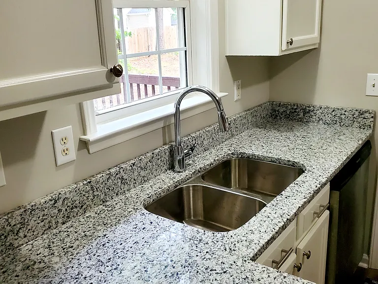 Freshly updated kitchen cabinets, new granite countertops & sink.