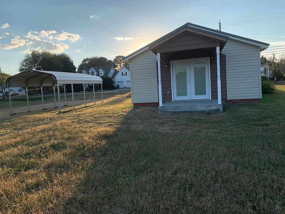 Front entrance and single carport