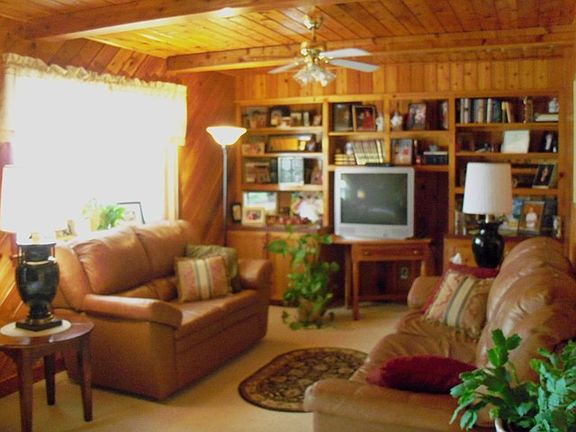 The living has a "warm" feel with the wood and the built-in bookcase/shelving.