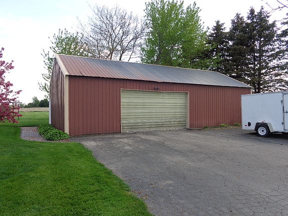 Desirable 48x24 pole Barn with a heated work shop or room for 4 cars. Blacktop driveway.