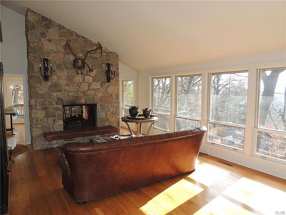 Double sided stone fireplace with raised hearth