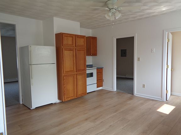 The other side of the kitchen with the additional cabinets, stove and refrigerator. Through the door is one of the bedrooms. The door to the right of the picture is the bathroom.
