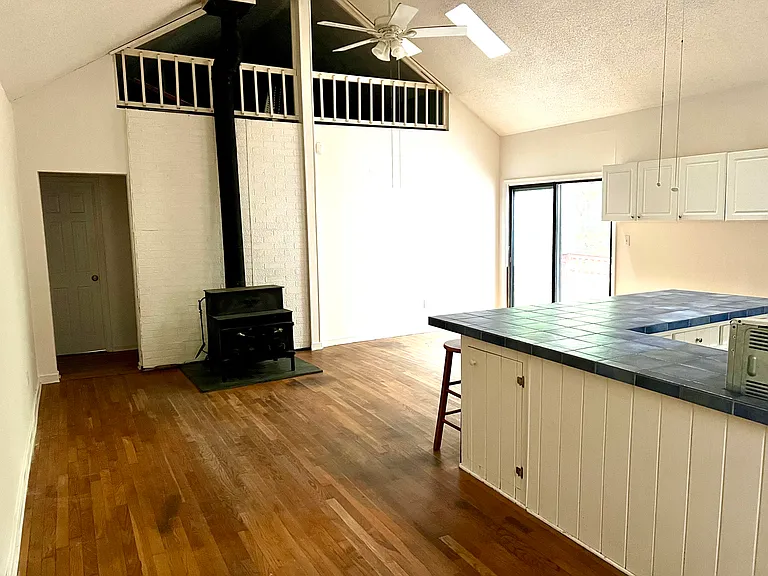 Kitchen, dining area, wood stove, and loft.