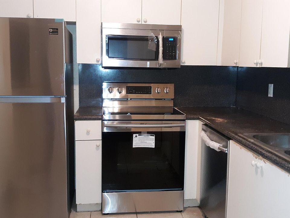 White shaker cabinets with stainless steel appliances