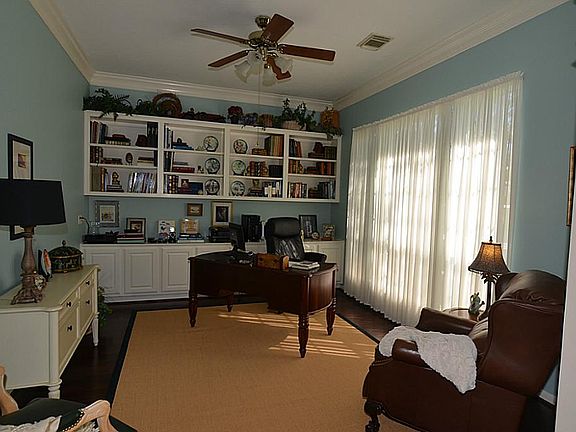 Spacious Study w/Great Views of Front Yard, Crown molding, Rich Hardwood Flooring & Custom Built-Ins