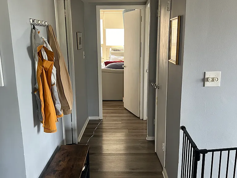 Spacious hallway leading to the bedroom wing and full bathroom.