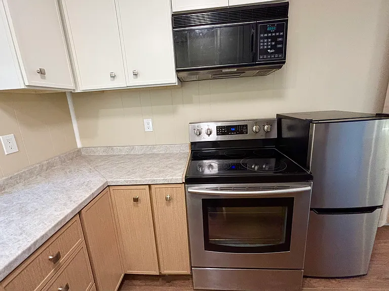 Stove, Frig and Microwave with ample kitchen cabinets