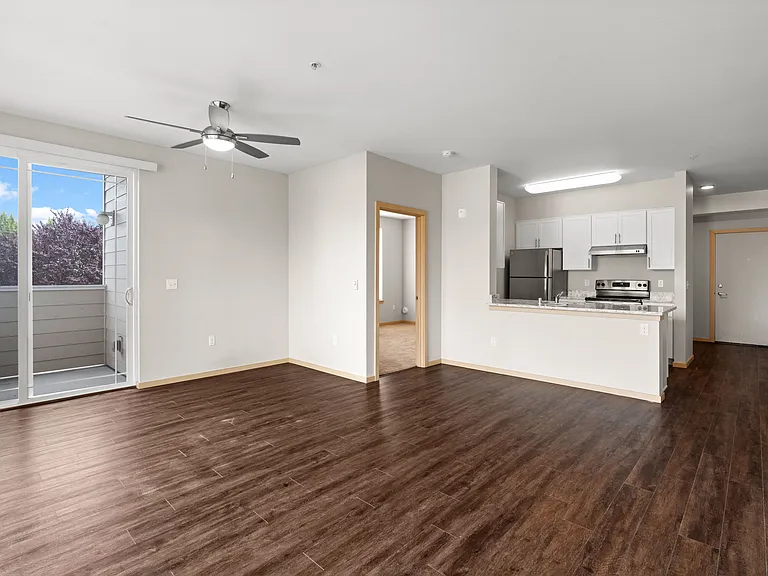 Open-concept living space with modern finishes and balcony access.