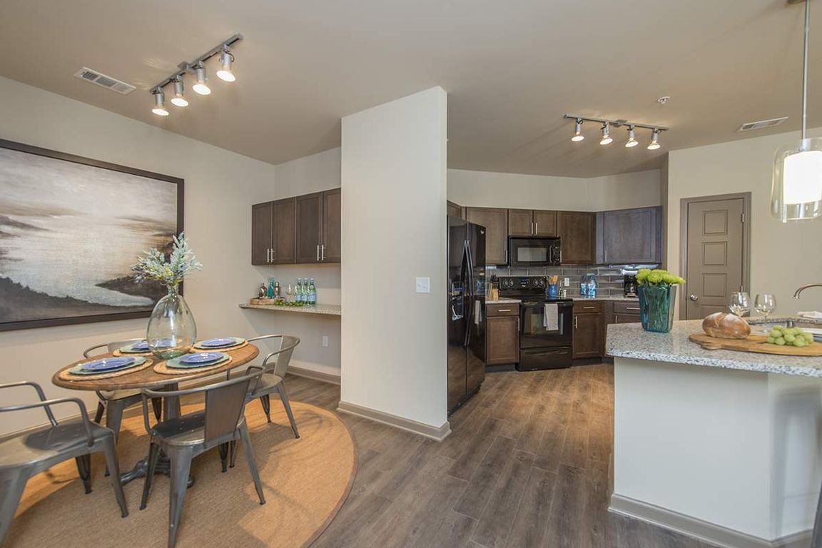 Spacious Dining Room with Work Area and View into Large Open Kitchen | Apartments in Nashville | 909 Flats