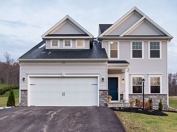 Front exterior of Crestmont B floorplan by S A Homes - two story home with vinyl siding, partial sto
