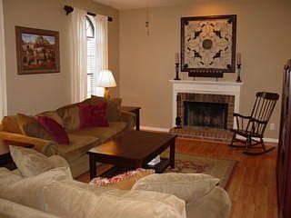 Spacious living room with woodburning fireplace.