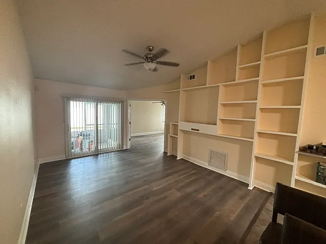 Living room with display shelves and large screen TV mounting