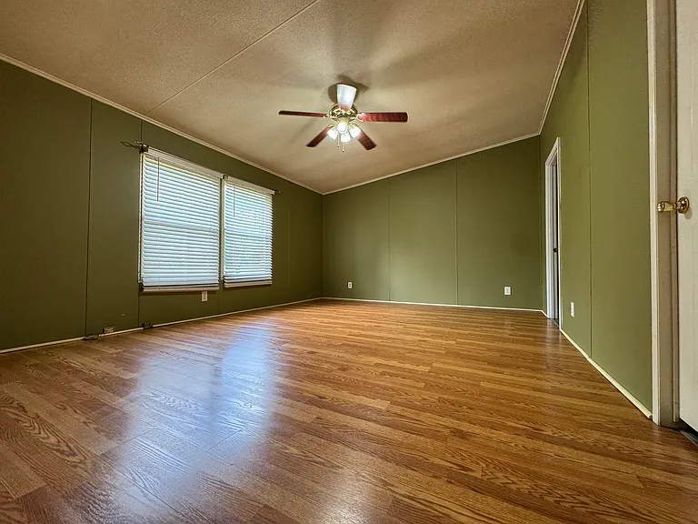 **The spacious primary bedroom features a large walk-in closet and offers convenient access to both the living room and the private en-suite bathroom.**