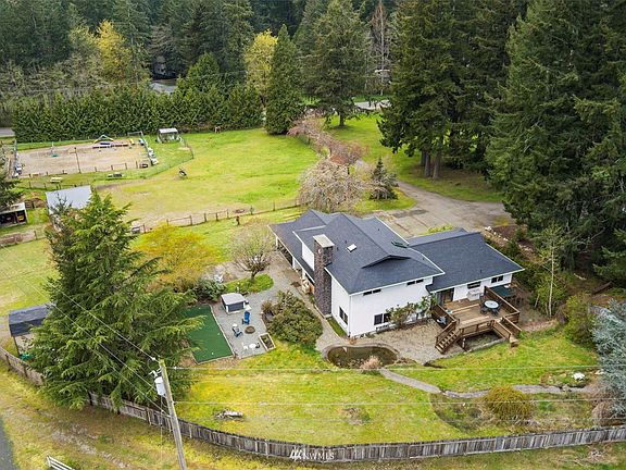 Tall trees offer privacy from the road. Putting green and frog pond in the back yard.