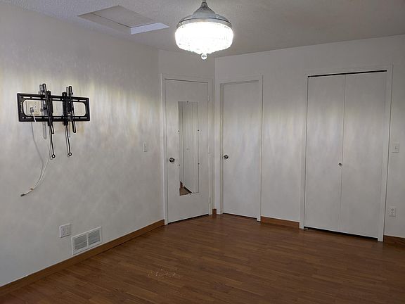 Large master bedroom with walk in closet and access to bathroom.