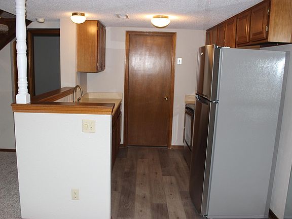Kitchen has brand new stainless steel refrigerator, range, and dishwasher. It also has a built-in microwave.