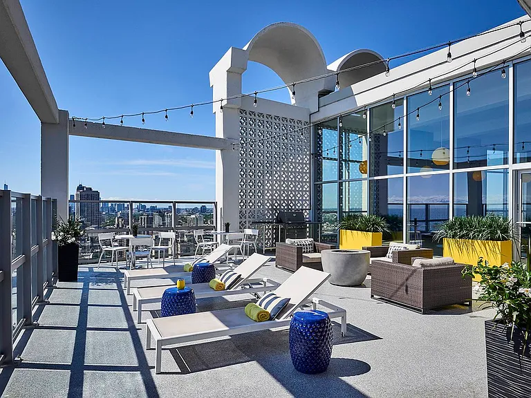 Rooftop sun deck with fire pit and grilling station