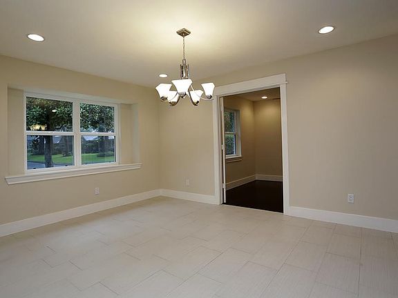 As you enter the property, the expansive dining room is to your left. Updated tile flooring, recesse