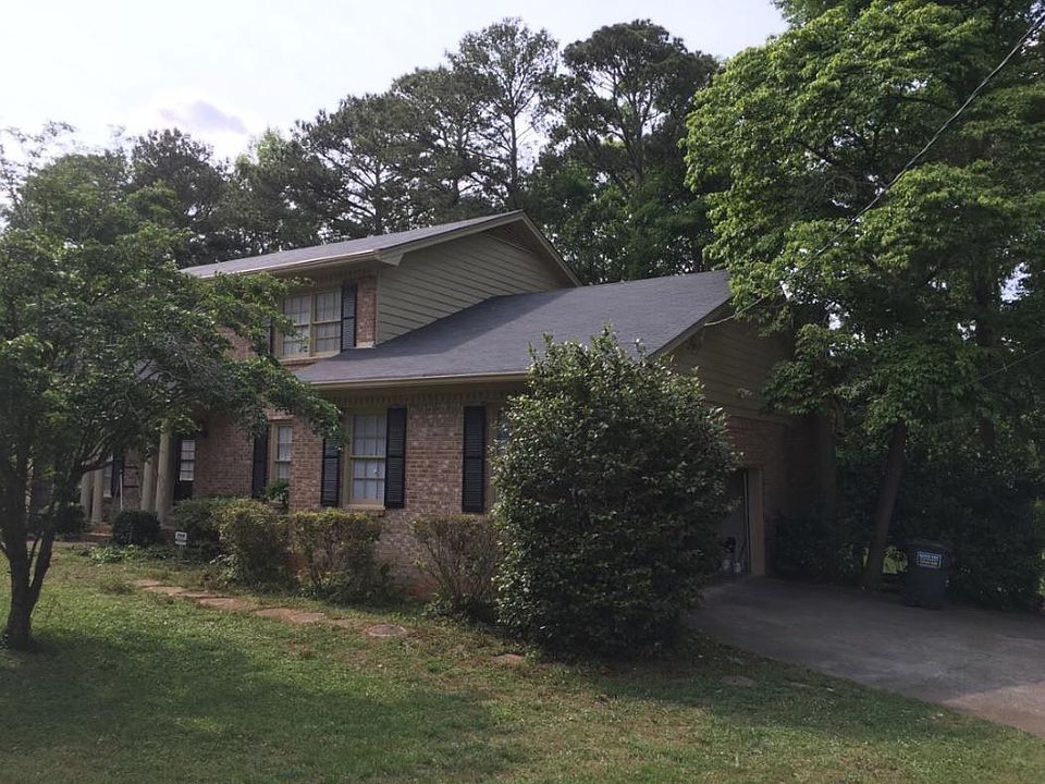 Front view of house, with new roofing and garage shown.