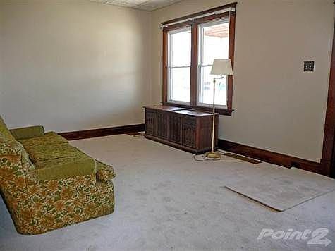 This 20 x 11 living room is freshly painted and has new carpet.