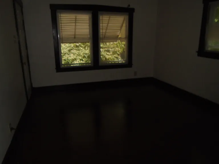 Spacious bedroom with mid-sized closet and large windows