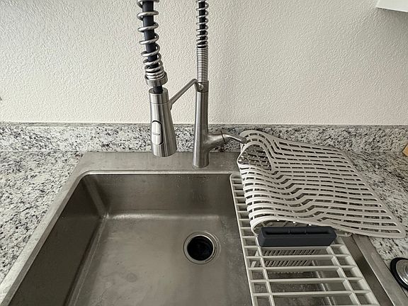 Amazing farm sink. deep, large flexible spray faucet