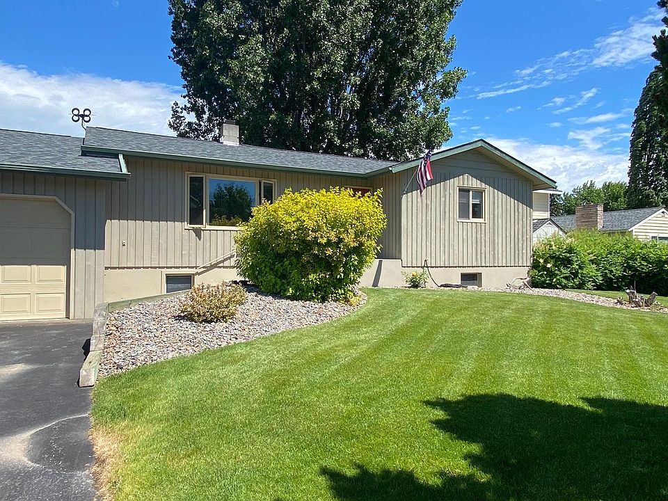 Front of house with immaculate lawn.