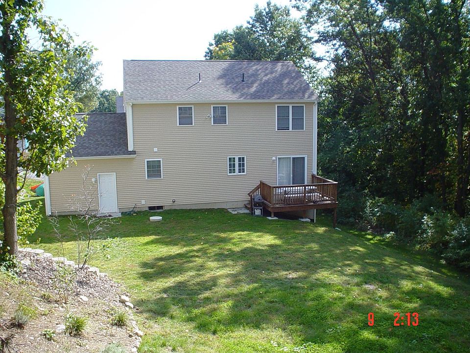 Back of the home - Includes a deck with a grilling area. Woods provide shade! 