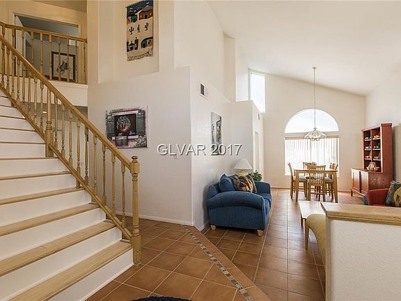 Vaulted ceilings with tile flooring in this spacious living and dining area.