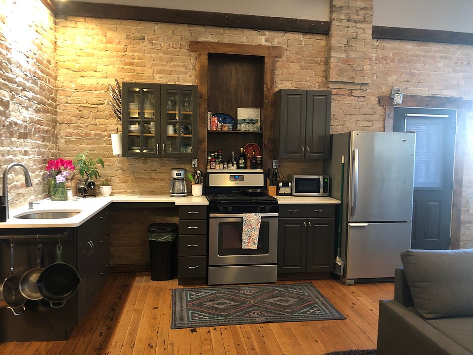 Stainless steel appliances, gas range/oven, toaster, microwave, and fridge included. Quartz countertops.