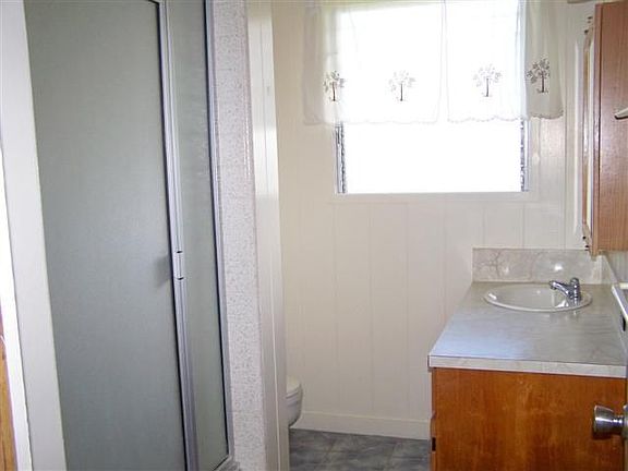 Freshly painted bathroom with small tub and shower