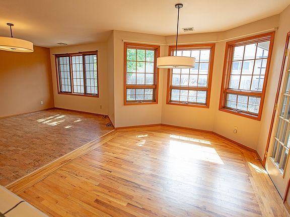 Great room layout. Living room to the left, dining straight ahead. Door to the right opens to a covered deck. Open kitchen is to the back of the photographer.