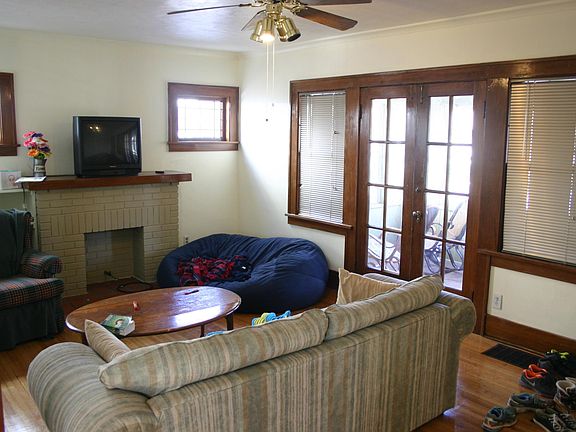 Living room with decorative fireplace, natural trim, and fr