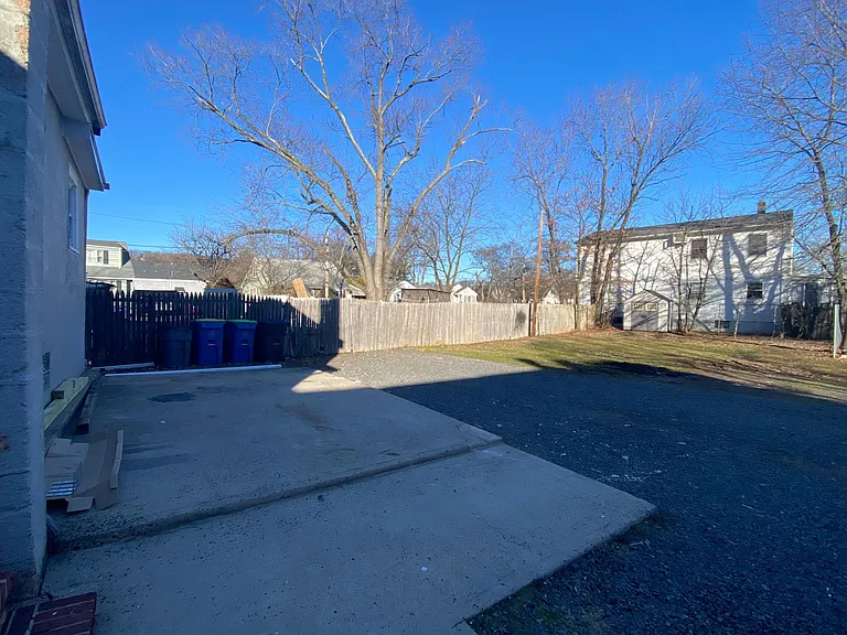 view of cement patio/parking/back yard/shed in back