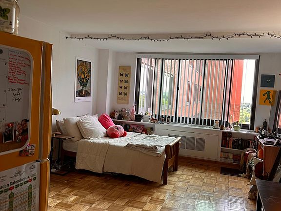 Looking into room as furnished by a past tenant. Photo taken standing at front door with refrigerator on left.