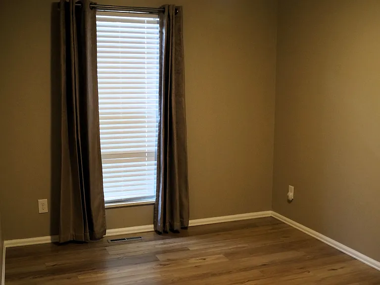 9' X 15'Secondary bedroom. Faux wood blinds and thermal blackout curtains.