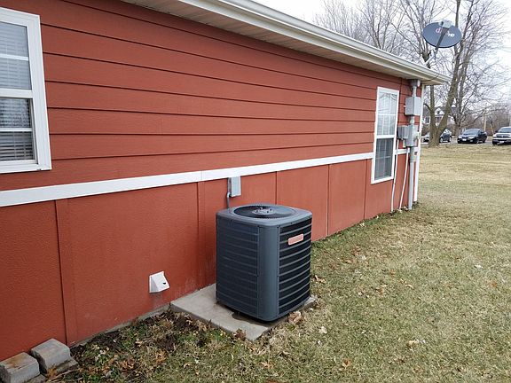 Central Air Compressor on concrete pad.
