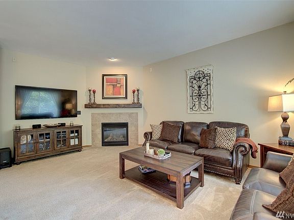 The Great Room features a gas fireplace and a perfect niche wall for a giant flat screen TV!