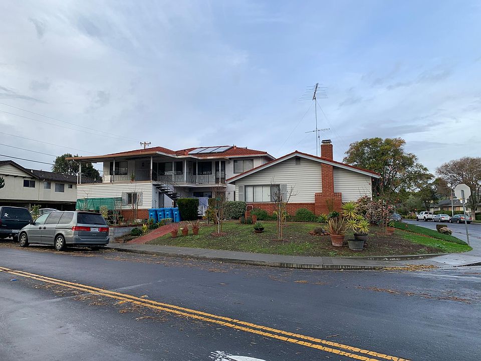 Street view of apartment complex. Upper unit is on the left side with the covered patio.