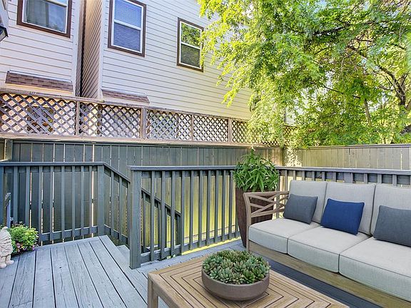 virtually staged back deck. lots of room and privacy in backyard with nylon, pet-friendly astroturf