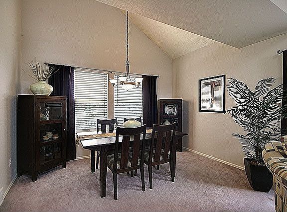 Formal din rm features neutral carpet & attractive light fixture.